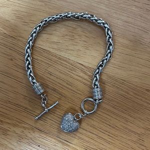 Sterling silver bracelet with heart pendant.